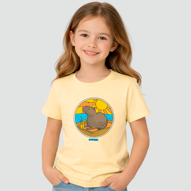 Menina usando camiseta infantil amarela com estampa capivara na praia
